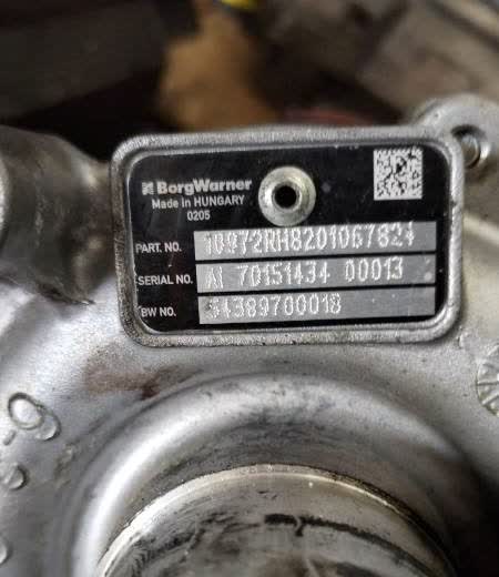 Compressor plate on a turbo. Photograph the stamped metal tag.